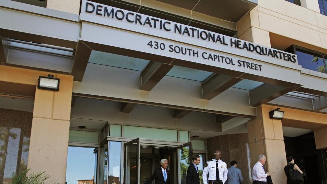 In this June 14, 2016 file photo, people stand outside the Democratic National Committee (DNC) headquarters in Washington. (AP Photo/Paul Holston, File)