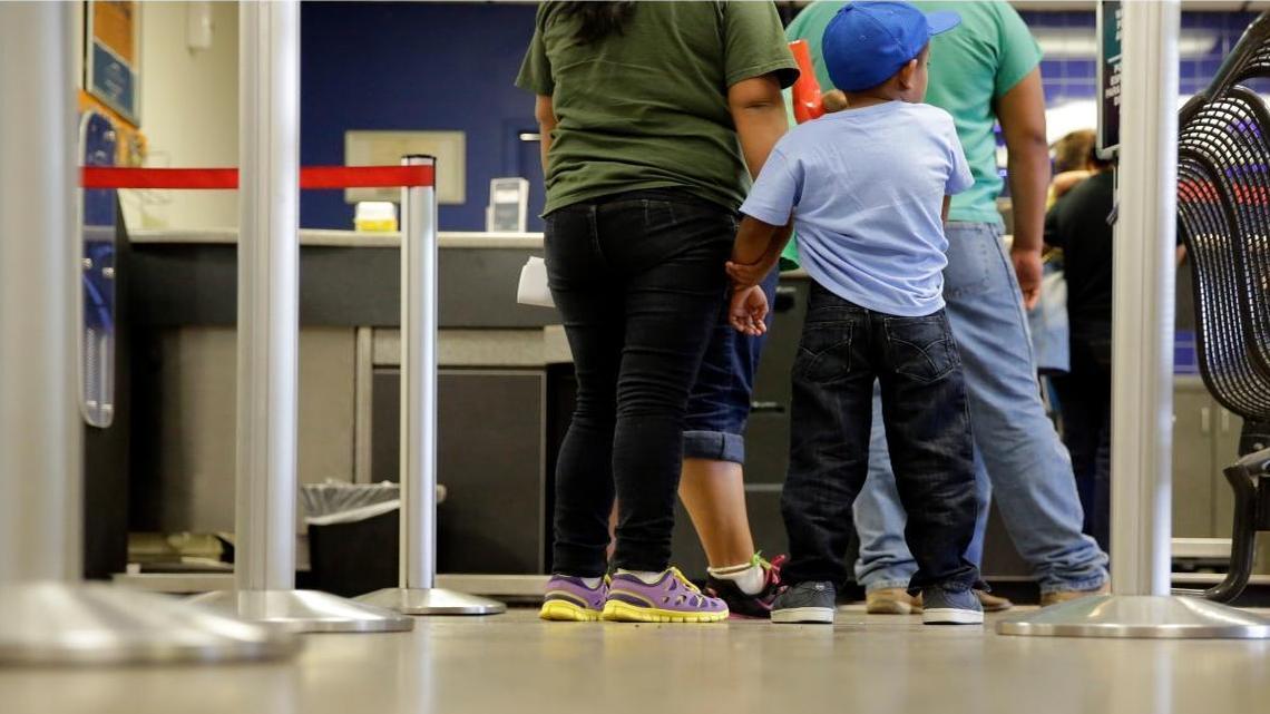 In this photo taken July 7, 2015, immigrants from El Salvador who entered the U.S. illegally stand in line at a bus after they were released from a family detention center Texas. Nearly a dozen mothers at a family detention center in Pennsylvania have launched a hunger strike to protest their long detentions.