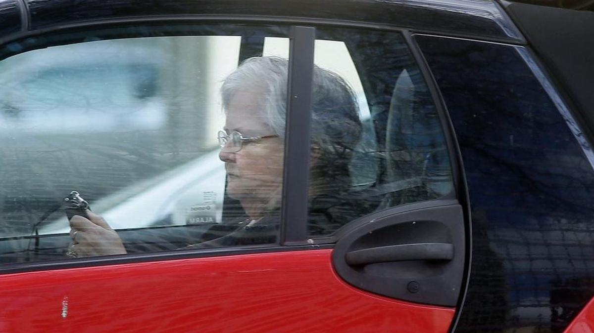 A driver looks at her phone while making her way through traffic in Dallas last spring.