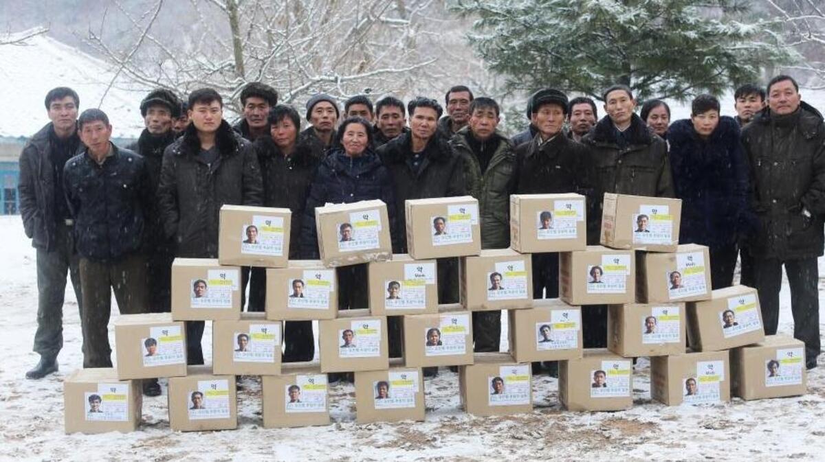 A group of North Korean tuberculosis patients stand in front of packages of medicine used to treat drug-resistant TB at a clinic in the southwest of the country. This month, an international fund announced it was ending grants for TB treatment in North Korea. That decision could add to the challenges faced by NGOs such as the Eugene Bell Foundation, which works in North Korea to treat drug-resistant TB.