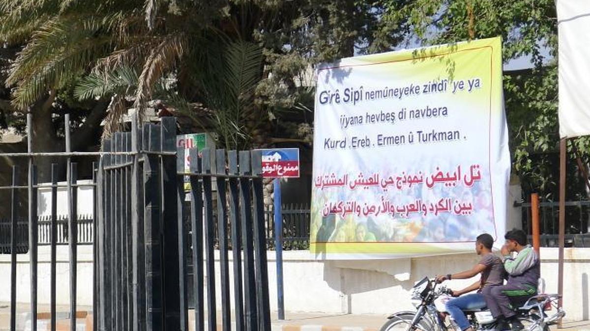 Until June, Islamic State extremists used this fenced-in fountain on a main traffic circle in Tal Abyad to behead those they labeled criminals or enemies of the state. Today, a banner outside the city’s municipal headquarters uses the city’s Kurdish name, Giri Spi, to declare it “the living symbol of coexistence between Kurds, Arabs, Armenians and Turkmans.”