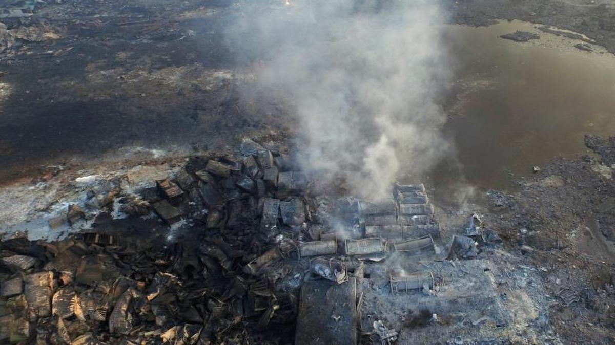 
Smoke rises from debris near a crater that was at the center of a series of explosions in northeastern China's Tianjin municipality Saturday, Aug. 15, 2015. New explosions and fires on Saturday prompted authorities to order an evacaution zone of nearly two miles around the site.
