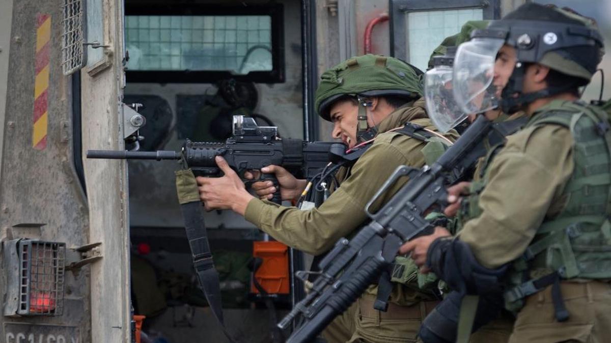 
Israeli troops take aim, during clashes with Palestinians near Ramallah in the West Bank on Friday. 
