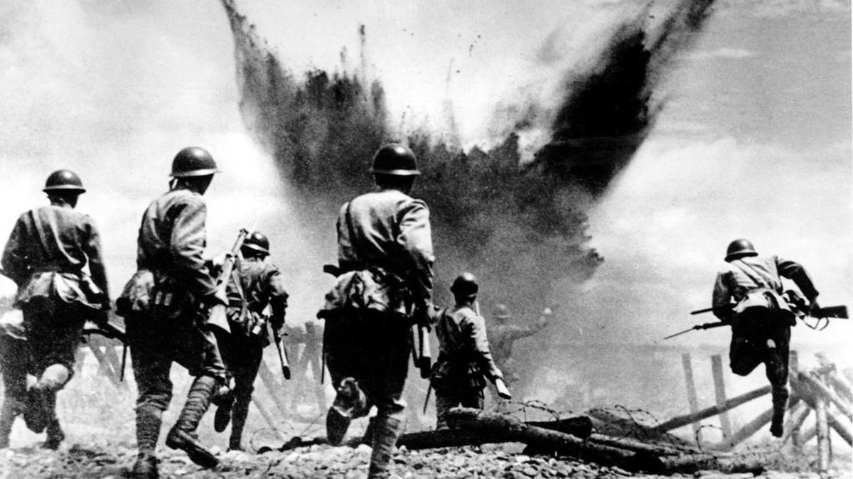 
Japanese infantrymen advance with rifles and grenades, leaping over barbed wire and preceded by an artillery barrage, in the Peking sector in China on Aug. 19, 1937 during the Second Sino Japanese War. Heavy casualties occurred on both sides, but Chinese losses outnumbered the Japanese five to one.
