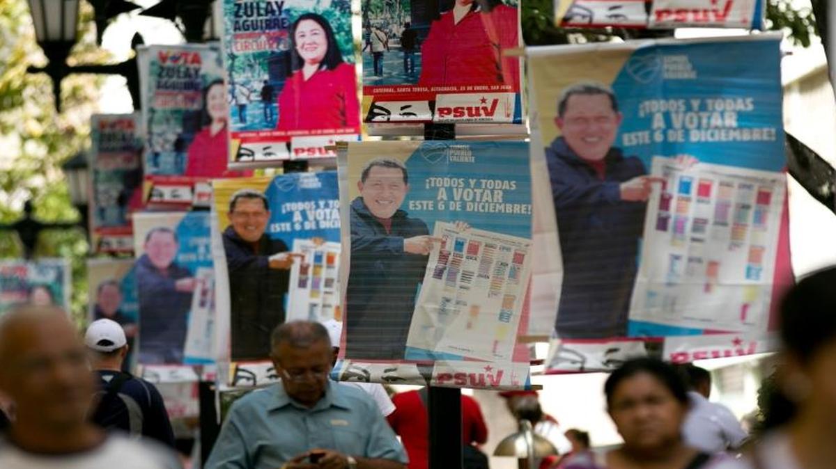 Posters Saturday showing the late President Hugo Chavez called for voters to pick pro-government parties in Sunday’s election.