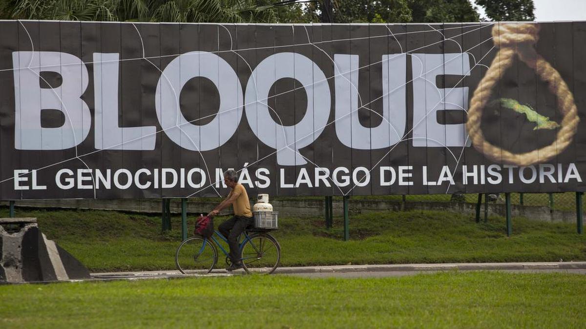A man passes an anti-embargo billboard in Havana that reads in Spanish “Blockade: The longest genocide in history.” Cuba has insisted that the embargo must be lifted before the United States and Cuba can have normal relations.