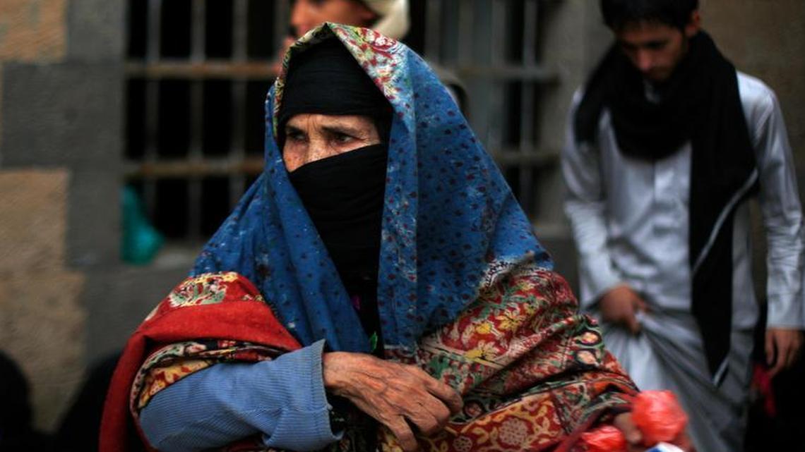 
An elderly Yemeni woman waits to receive free food donated by Yemeni volunteers during the holy month of Ramadan, in Sanaa, Yemen’s capital. A new Human Rights Watch report, released Tuesday, June 30, accuses Saudi Arabia of violating the laws of war with its aerial bombing. 
