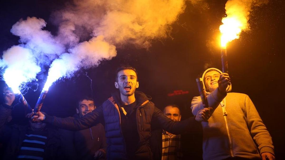 Supporters of Turkey's Justice and Development Party celebrate in front the AKP headquarters in Istanbul on Sunday.