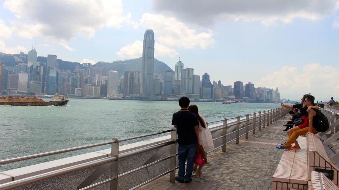 Tourists gaze at the skyline of Hong Kong from the Kowloon side of the territory on Sept. 23, 2015. Although life has returned to normal in Hong Kong, pro-democracy activists who launched last year's street protests say they have not given up on their cause.