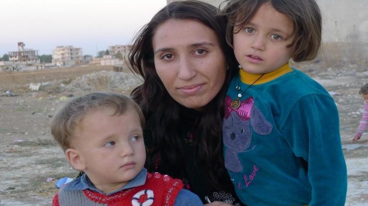 Berivan Hasan, 25, hugs her nephew Ronas, 2, and niece Renaz, 6, whose parents were killed when Islamic State insurgents briefly recaptured the Kurdish town of Kobani in northern Syria and wreaked havoc.