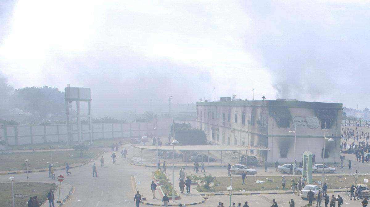 Buildings burn in a security forces compound in Benghazi, Libya.