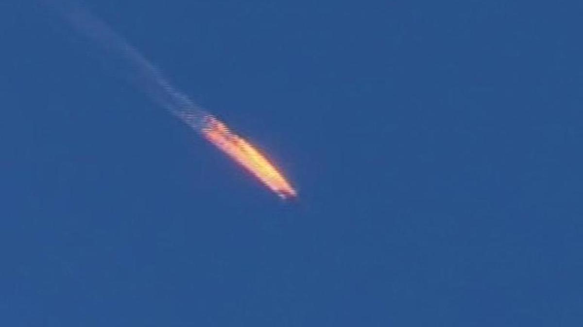 This frame grab from video by Haberturk TV shows a Russian warplane on fire before crashing on a hill as seen from Hatay province in Turkey. Turkey claimed the Russian plane had violated Turkish airspace and ignored repeated warnings. Russia denied that the plane crossed the Syrian border into Turkish skies.