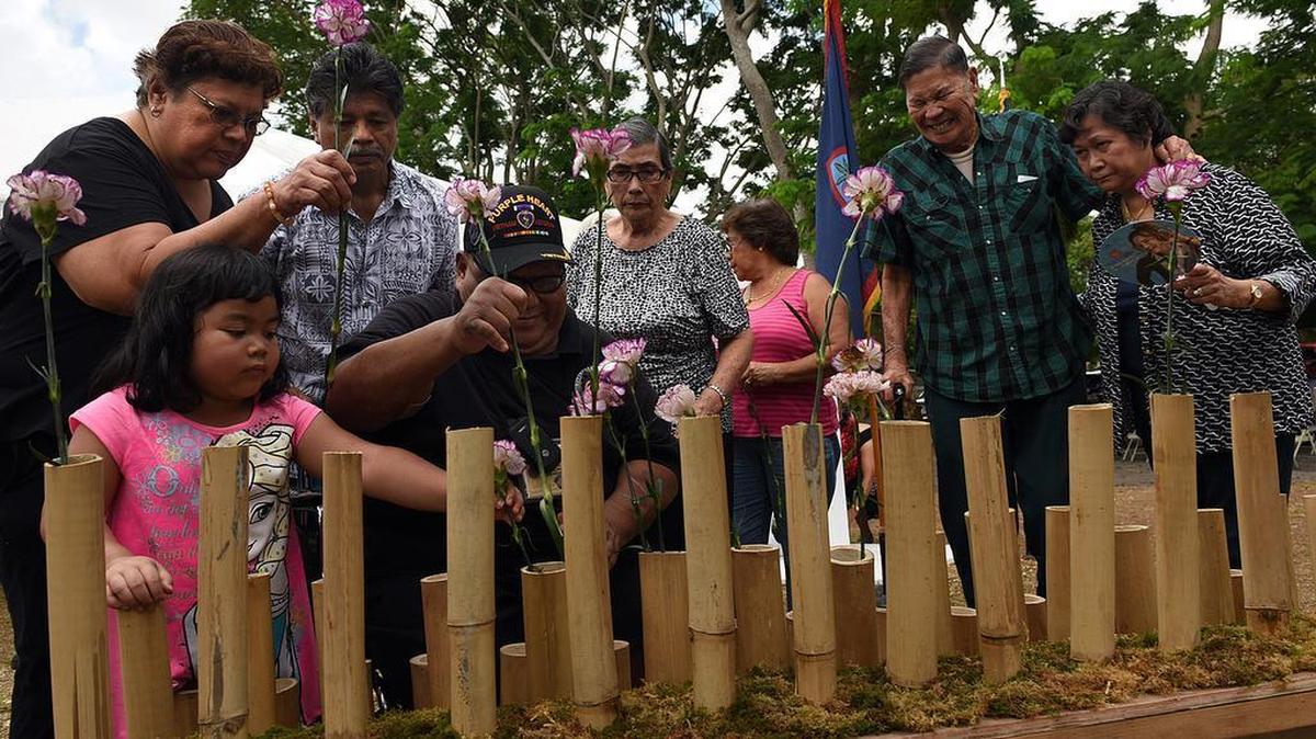 Relatives of the "Forgotten 45" place flowers at the annual Chagui'an Memorial in Yigo, Guam, on Aug. 7, 2015, where 45 Guamanians were massacred by the Japanese during WWII. U.S. Military planners are drawn to Guam and the nearby Mariana Islands for use as training grounds and as a hub in the western Pacific for submarines, jets and naval fleet vessels. The islanders want to see a smaller military presence on the territories the U.S. seized from Japan in WWII.