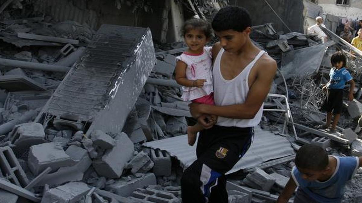 
A Palestinian inspects the debris of a house, which witnesses said was hit in an Israeli airstrike, in Rafah in the southern Gaza Strip on Aug. 2, 2014.
