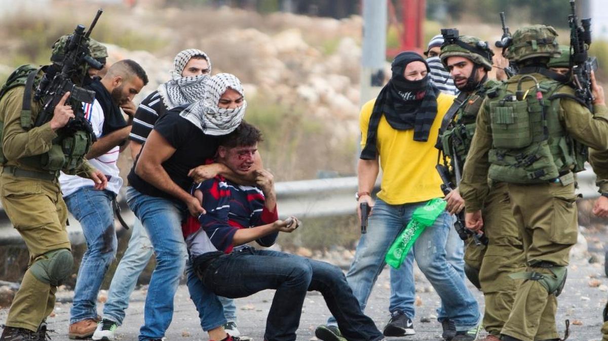
Undercover Israeli police officers and Israeli soldiers detain a wounded Palestinian demonstrator during clashes near Ramallah, West Bank on Wednesday. 
