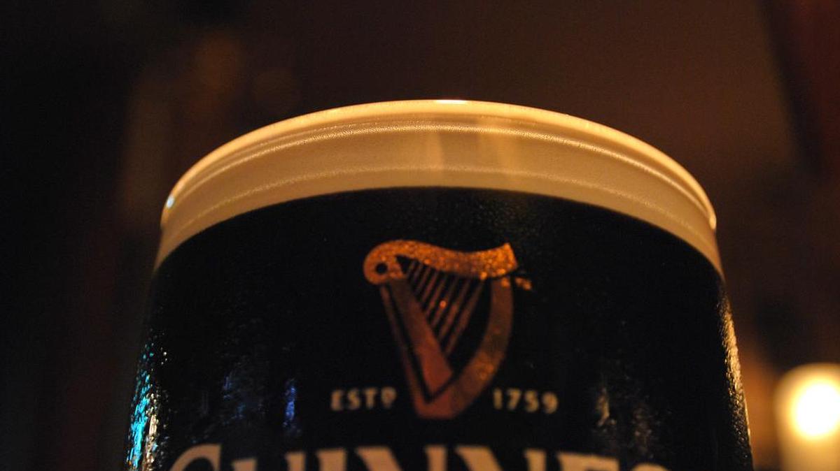 A classic Guinness pour reaches the very top of the glass and has a strong creamy head.