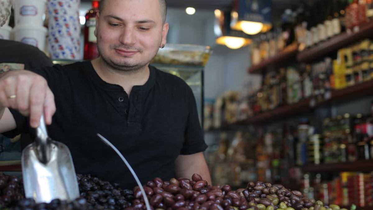 Eitan Levi scoops Greek olives he bought for cash at a steep discount in his Tel Aviv deli on July 20, 2015. Greece and Israel have drawn closer over the last five years, but the faltering Greek economy has kept trade at a trickle. Levi said he only imported Greek olives, oil and feta cheese because there were few other products Greece made better and cheaper than other producers.