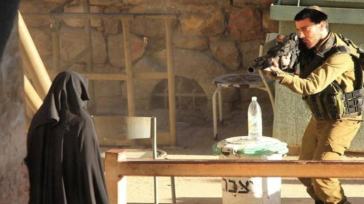 An Israeli soldier taking aim at a Palestinian woman at a checkpoint in Hebron, West Bank, in September. The photo was made available by the Youth Against Settlements, a Palestinian activist network the opposes Jewish settlements in the West Bank. The woman was shot to death. The Israeli military concluded an investigation that said the death was unnecessary.