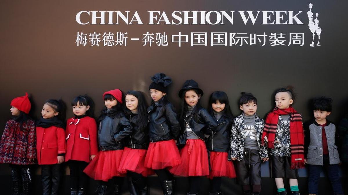Models for the children’s wear fashion show stand outside the venue during the China Fashion Week in Beijing on Thursday, Oct. 29, 2015. China’s ruling Communist Party announced Thursday that the country will start allowing all couples to have two children, abolishing an unpopular policy that limited many urban couples to only one child for more than three decades.