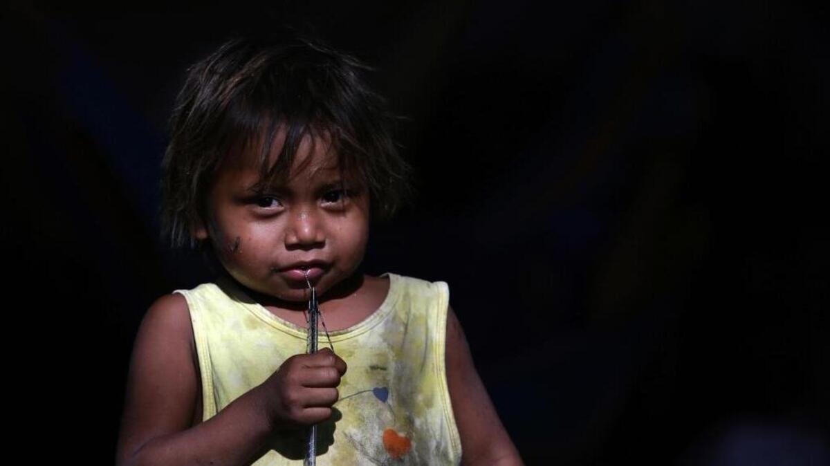 A Warao indigenous child from Venezuela eyes the camera at an a shelter in Pacaraima, the main entry point for Venezuelans, in the Brazilian northern state Roraima.