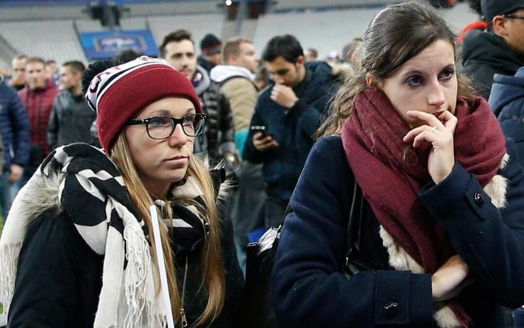 Soccer fans waited on the field at the Stade de France stadium on Friday night. Terrorist suicide bombers failed to gain admission to the stadium, which experts say probably had been the primary goal of the attackers.