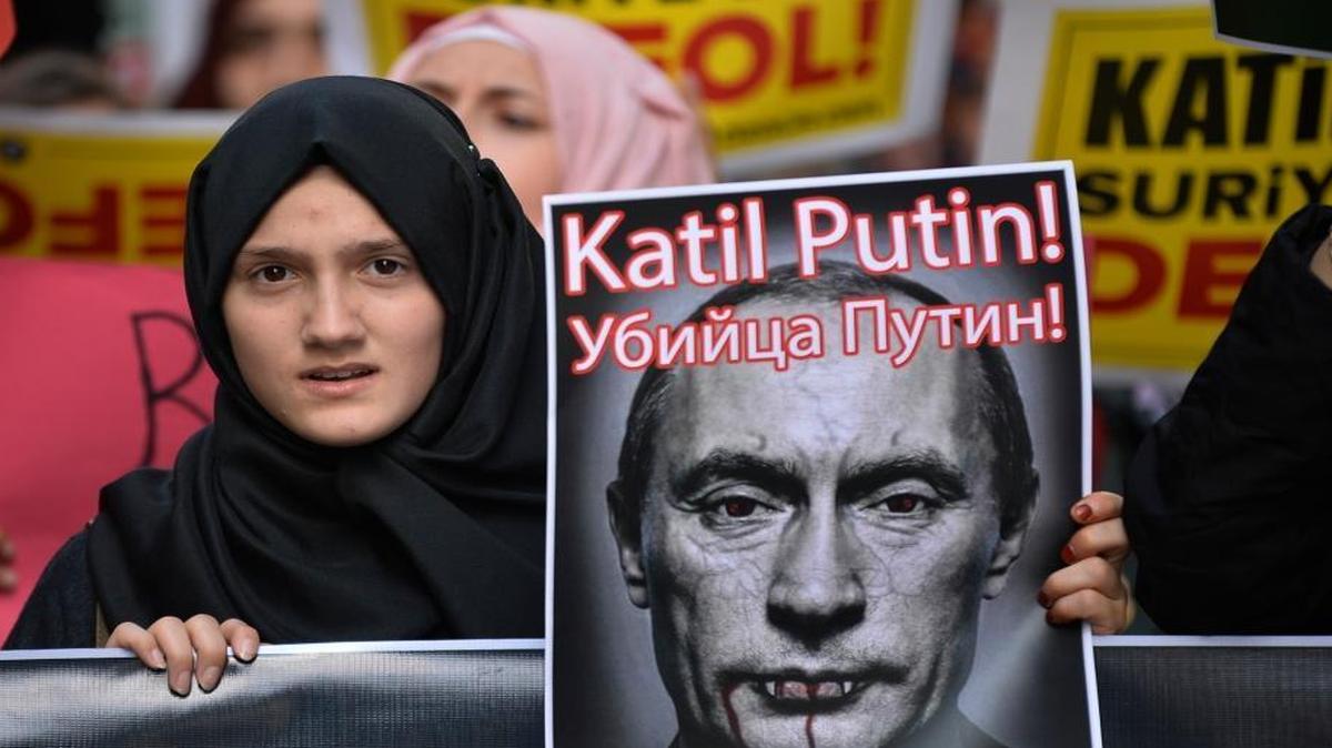 
An anti-Russian demonstrator in Istanbul, Turkey, Saturday held up a caricature of Russian President Vladimir Putin during a protest against Russian military operations in Syria. The picture reads in Turkish and Russian: “Murderer Putin.” 

