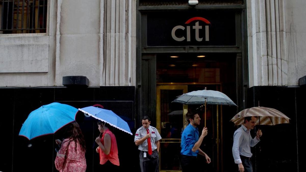 People pass by Citibank offices in Buenos Aires. Citibank says it will sell its direct banking operations it’s had for a century in Argentina, Brazil and Colombia at a time when the three largest economies in South America are suffering setbacks.