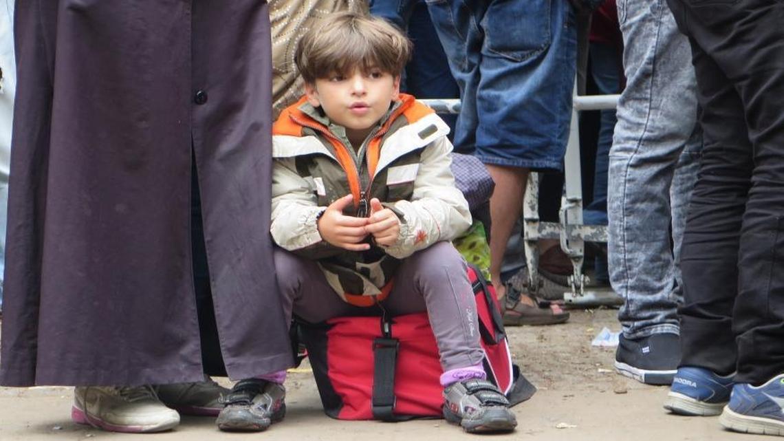 
Many children are among hundreds of refugees waiting in the courtyard of the Berlin Office for Health and Social Affairs on Sept. 3, 2015. They are waiting on appointments that will lead to assignments to their new, temporary homes, in Germany. In all, Germany is expecting 800,000 to a million refugees this year, and thus far has accepted about half the asylum requests it has received.
