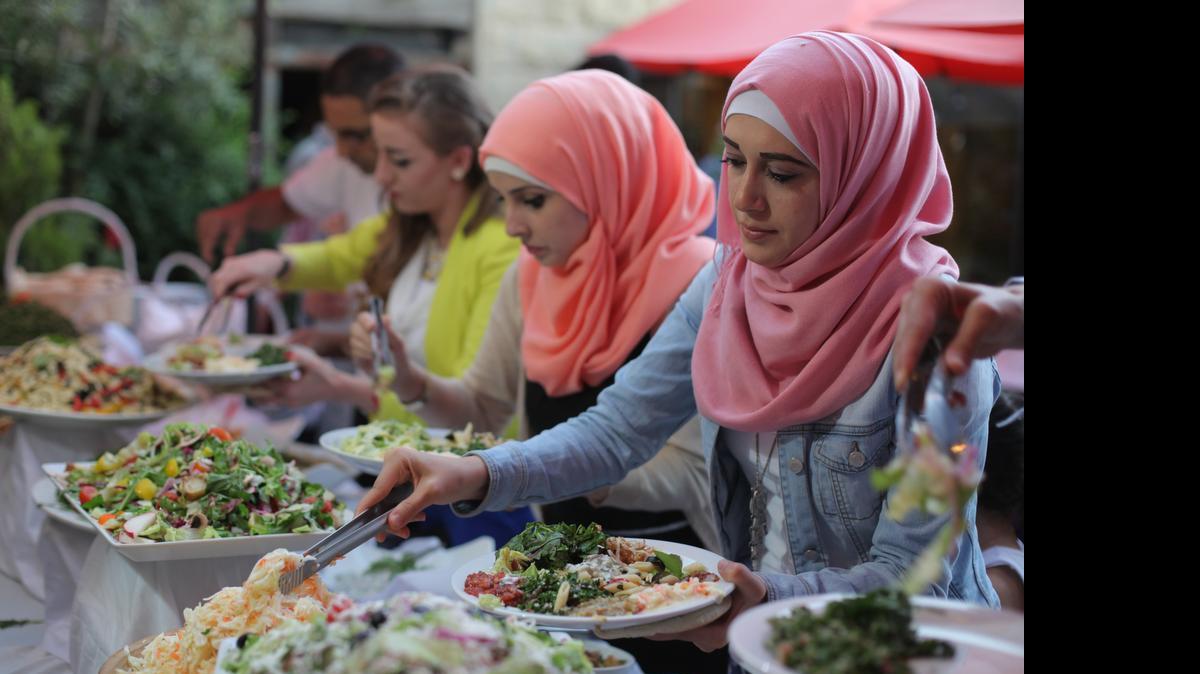 In Ramallah's Orjuwan restaurant, guests pile bright salads on their plates to break the Ramadan fast with the Iftar meal on July 9, 2015. Anticipation of dinner has transformed the ascetic month into a gourmand's holiday across the affluent Muslim world, but political realities, economic strain and conservative tastes have sliced down the ambitions of Ramallah's food professionals.
