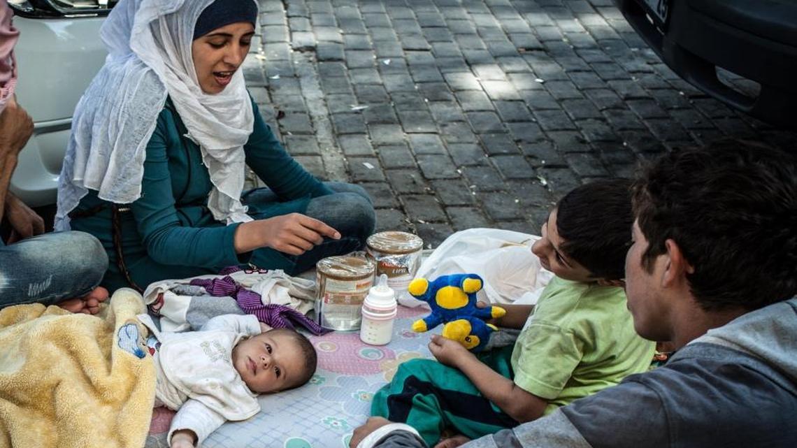 
A Syrian family stays on the street where they have been sleeping in Izmir, Turkey, while they attempt to reach Greece by boat on Sept. 3, 2015. This year, some 220,000 war refugees and economic migrants have arrived in Greece from Turkey and other Mediterranean jumping off points, according to U.N. figures.
