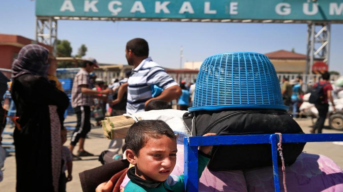 
Syrians were photographed waiting to cross back to the border town of Tal Abyad in Syria from Turkey on June 17 after Kurdish fighters evicted the Islamic State. Turkey said Friday it was willing to reach out to the YPG Kurdish militia in a search for a way to collaborate on preventing the Islamic State from capturing villages north of Aleppo.
