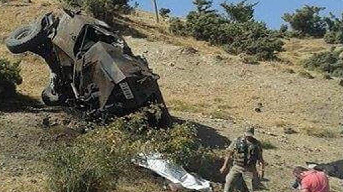 A Turkish soldier and a security member investigate the site where soldiers were killed by a roadside bomb detonated by Kurdish rebels in the eastern Turkish city of Siirt on Aug. 19, 2015, Turkish news agencies said. At least 85 people, most of them police and soldiers, have been killed since July in the renewed violence between the security forces and the Kurdistan Workers' Party, or PKK.