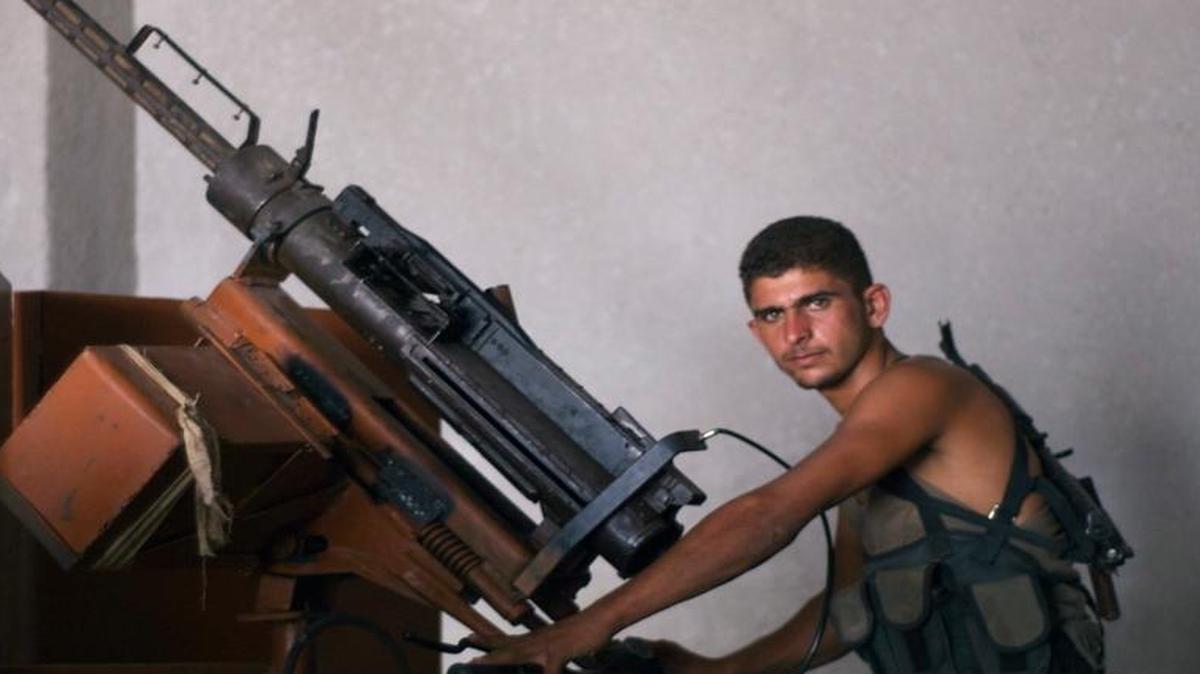 An Ahrar al Sham fighter manned an anti-aircraft gun in a photo taken in August 2012.