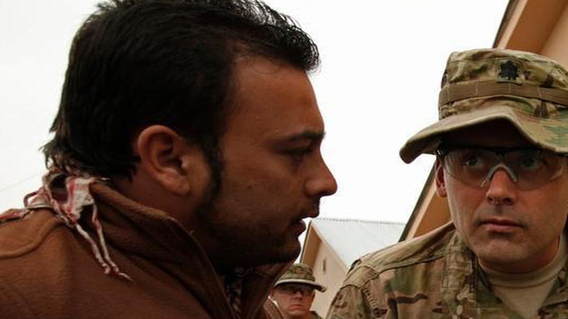 
Interpreters like the man on the left were critical for U.S. military officers who needed to converse with their Afghan counterparts. 
