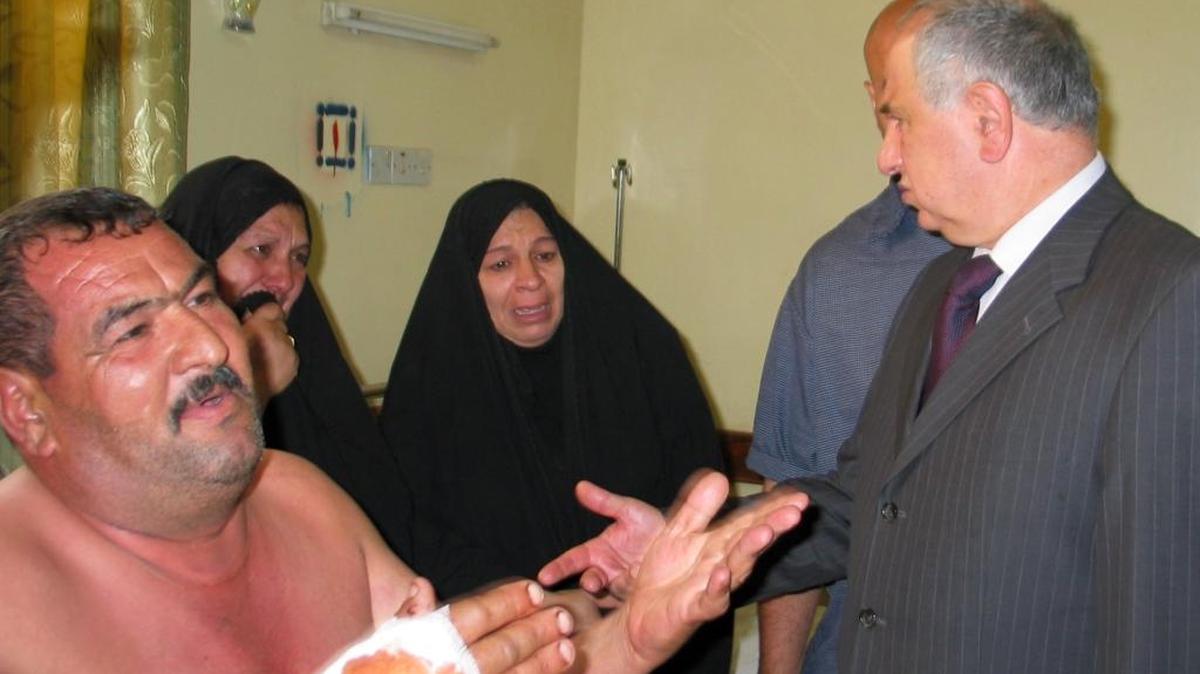 Ahmad Chalabi with victims of a suicide bomber in Musayyib, Iraq, July 18, 2005. Chalabi was a rare Iraqi politician, who lived outside the U.S.-protected Green Zone and traveled to danger zones.