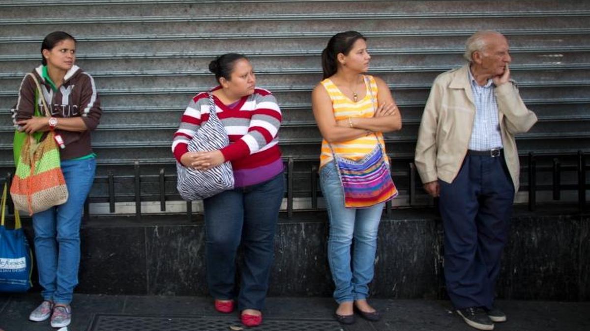 People wait in line to buy groceries at government-regulated prices in Caracas, Venezuela. Low oil prices are wreaking havoc and causing uncertainty for some governments and businesses in Latin America but opening an opportunity for U.S. officials to press their country’s energy agenda.