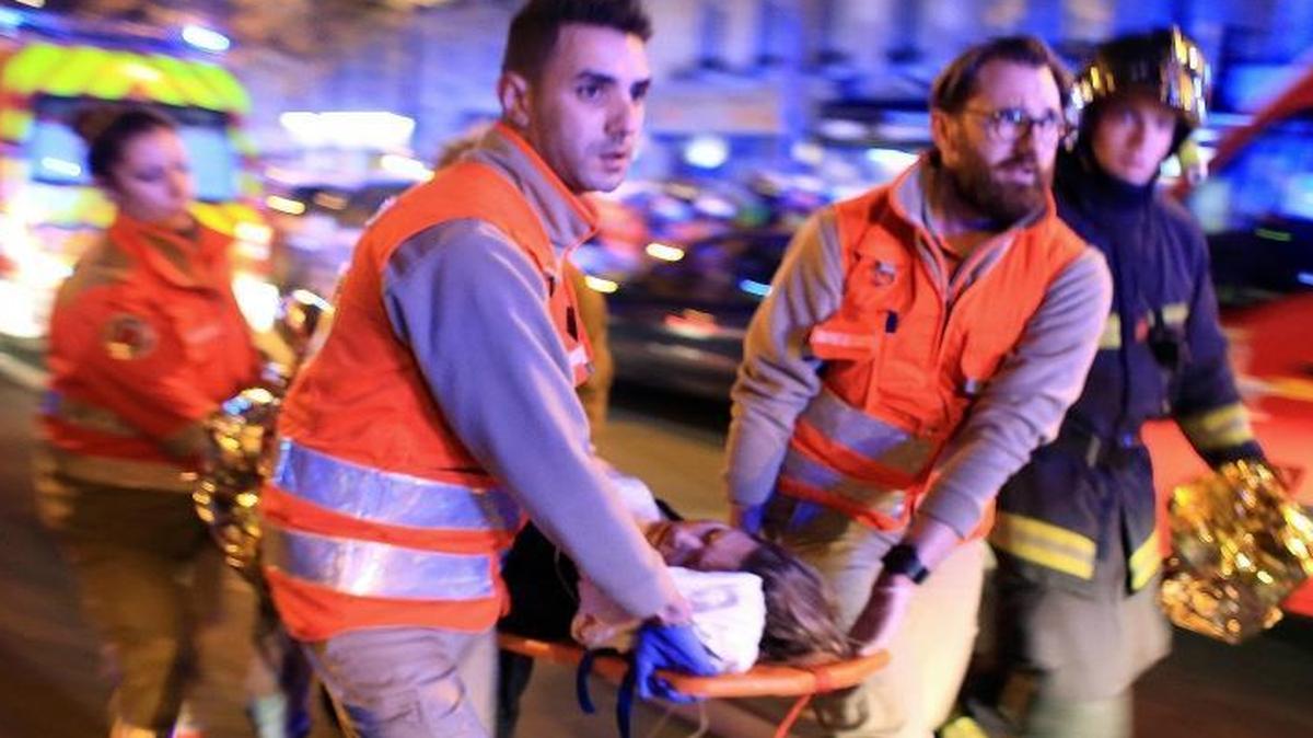 A woman being evacuated from the Bataclan theater after the terror attacks of Nov. 13. A phone discarded in a public trash can nearby helped police locate the attackers five days later.