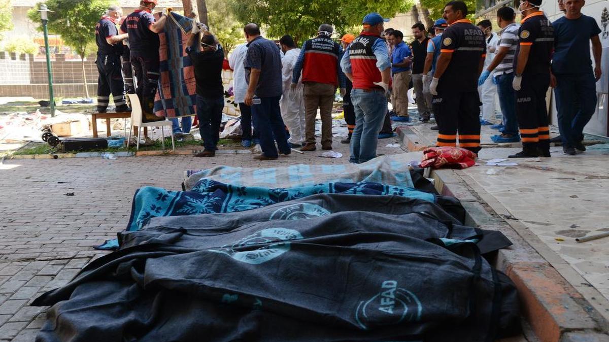 
Bodies of victims are laid out in the streets of Suruc, Turkey, after a blast Monday, July 20, 2015, that Turkish authorities were blaming on the Islamic State
