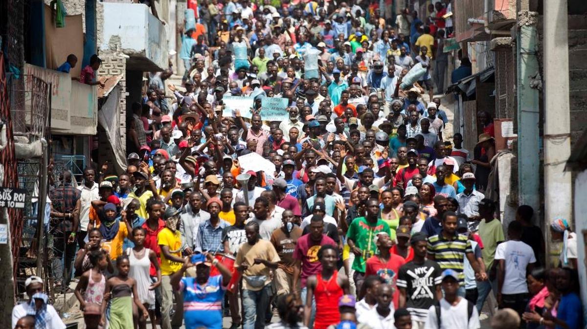 Demonstrators march during a protest against government tax hikes in Port-au-Prince, Haiti, Thursday Sept. 28, 2017. In early September, lawmakers approved a budget that will raise taxes on products including cigarettes, alcohol and licenses.