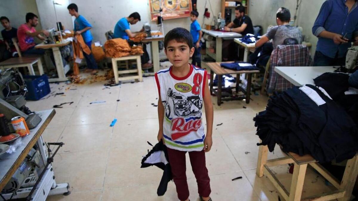 Syrian refugee child Ali from Aleppo, works at a clothing workshop in Gaziantep, southeastern Turkey.