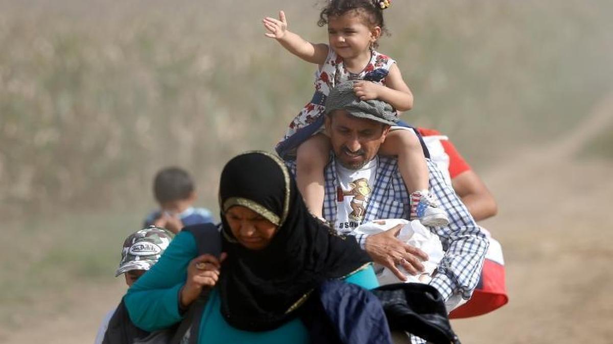 
A Syrian family arriving Wednesday at the border between Serbia and Croatia.
