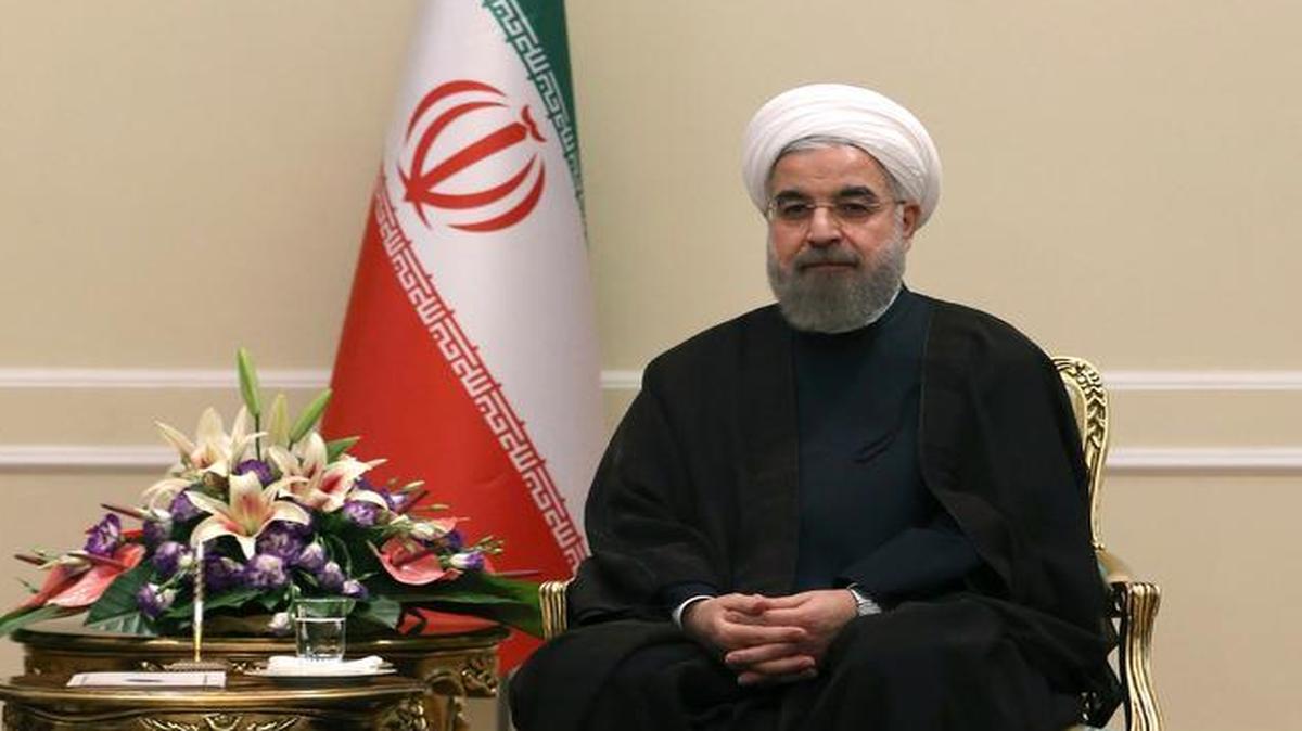 
Iranian President Hassan Rouhani, beneath portraits of the late Iranian revolutionary founder Ayatollah Khomeini and current Supreme Leader Ayatollah Ali Khamenei. Has Iran left its revolutionary roots behind?
