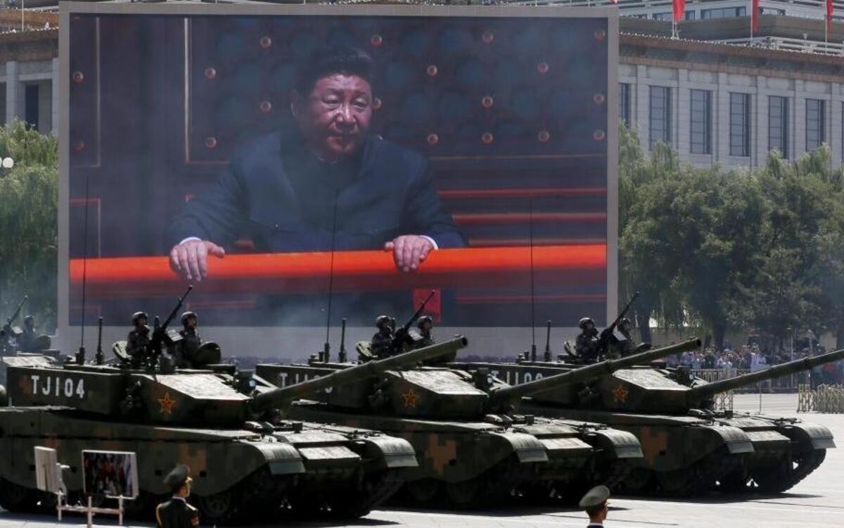 Chinese President Xi Jinping is displayed on a big screen as Type 99A2 Chinese battle tanks roll across during a parade commemorating the 70th anniversary of Japan's surrender during World War II at Tiananmen Gate in Beijing, on Sept. 3, 2015.
