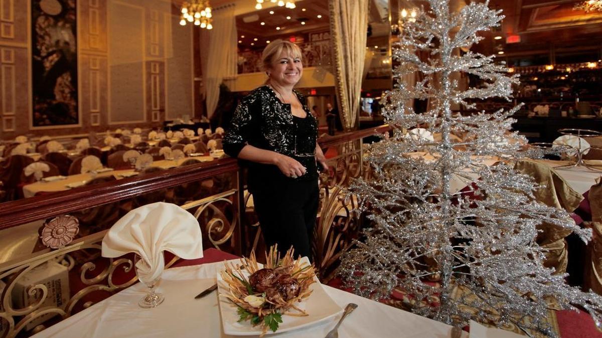 Tatiana Varzar presents Stuffed Quails in a Nest beside holiday decorations at her eponymous restaurant, Tatiana, in Hallandale Beach, Fla.