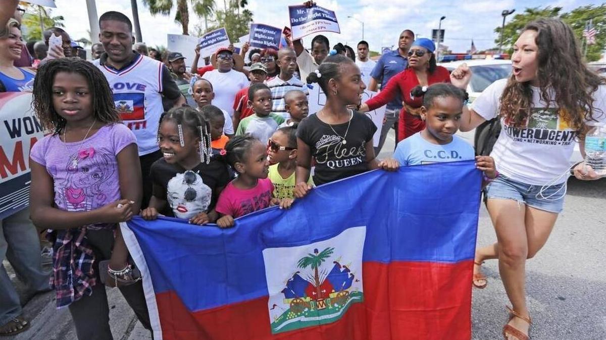 Haitian and immigration advocates hold a rally Saturday demanding the Trump administration extend Temporary Protected Status for Haitians as they march in front of U.S. Citizenship and Immigration Services office on Saturday, May 13, 2017.