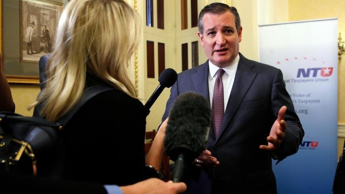 Sen. Ted Cruz, R-Texas, right, answers questions from reporters after a news conference about the Republican tax overhaul, on Capitol Hill in Washington.