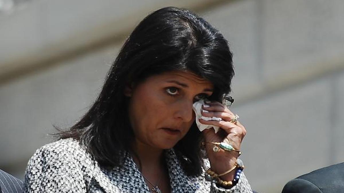
Gov. Nikki Haley wipes her face as the body of Sen. Clementa Pinckney arrives at the South Carolina Statehouse, Wednesday, June 24, 2015, in Columbia, S.C. Pinckney's open coffin was put on display under the dome where he served the state for nearly 20 years. Pinckney was one of those killed in a mass shooting at the Emanuel AME Church in Charleston. 
