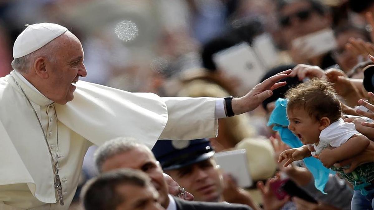 
Pope Francis blesses a child as he arrives for the weekly general audience in St. Peter's Square at the Vatican, Wednesday, Sept. 16, 2015. 
