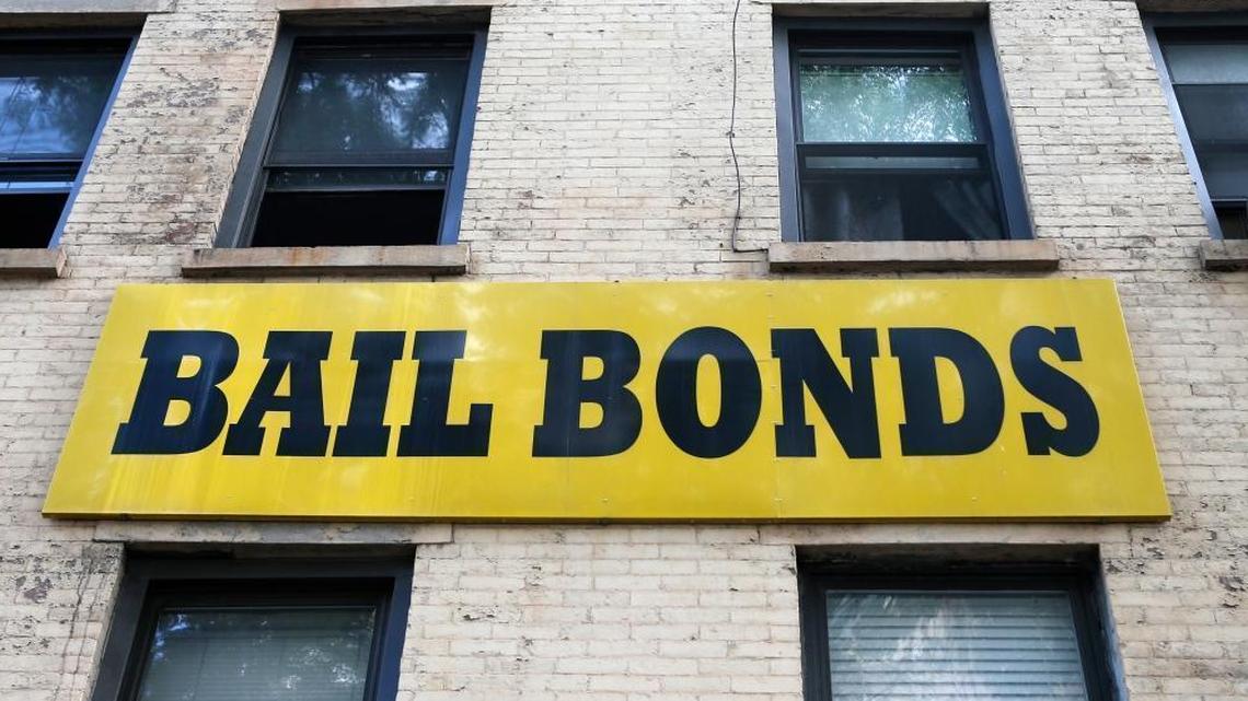 In this photo taken Tuesday, July 7, 2015, a bail bonds sign hangs on the side of a bail bonds business near Brooklyn's courthouse complex and jail in New York.