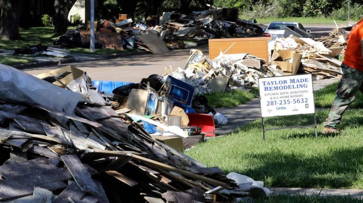 A remodeling sign sits in a yard outside a home damaged by floodwaters from Hurricane Harvey, in Houston. Victims of Hurricane Harvey, desperate to rebuild their homes and lives, are facing the harsh reality that it may take months for an overwhelmed construction industry to address their needs.